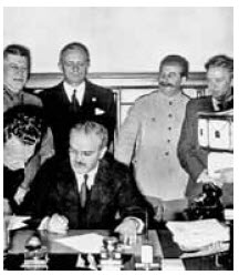 Molotov signs the Nazi–Soviet non-aggression pact. Behind him are Ribbentrop and Stalin. 