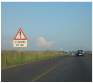 Certain places in South Africa, such as this one on the N4 near Witbank, feature signs warning of vehicle hijackings. (Photo: Zakysant )