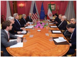 U.S. Secretary of State John Kerry, with State Department officials and others, sits across from Iranian Foreign Minister Mohammad Javad Zarif and advisers in Lausanne, Switzerland, before resuming negotiations about the future of Iran's nuclear program. (Photo: State Department)