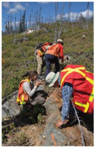 Junior mining exploration geologists examine a possible find. (Photo: Eastmain Resources, Inc.)