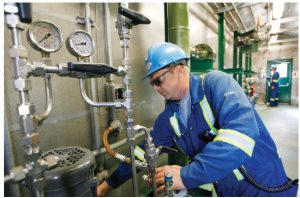 Operator Dean Douthwright, of Corridor Resources, checks the methanol injection pump at a Sussex, N.B., operation that produces natural gas from shale.