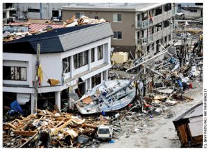 A fishing boat sits bizarrely on its side, swept ashore during the massive tsunami that struck this Japanese fishing port. The town was devastated by the 9.0-magnitude earthquake that triggered the tsunami. 