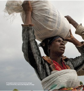 A Congolese woman receives food at a refugee camp in North Kivu, Democratic Republic of Congo. 