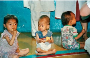 Nursery school children in a village northwest of Pyongyang, North Korea, receive rations of food. 