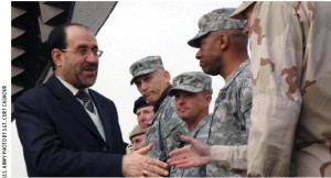 Iraqi Prime Minister Nouri al-Maliki greets U.S. soldiers during Iraqi Army Day.