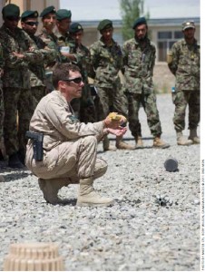 Warrant Officer Tim MacCormac demonstrates how to prepare a charge to dispose of unexploded ordnance during a class with Afghan National Army (ANA) soldiers.