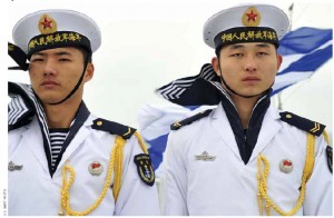 Navy sailors from the People's Liberation Army stand at attention on a ship in Qingdao, China. 