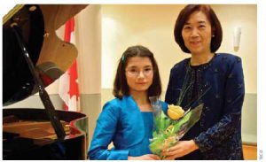 Dr. Chih-Kung Liu, representative of the Taipei Economic and Cultural Office in Canada, and his wife Huey-Pyng Liu, right, hosted a fundraising dinner that featured the music of violinist Maria Kristic, left, among others.