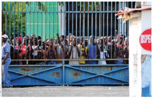 Haitians wait for water and supplies being delivered by helicopters as part of relief efforts in Haiti after the 2010 earthquake