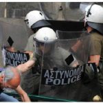 A Greek protester clashes with riot police in Athens in June 2011.