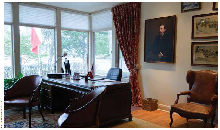 Mr. Ibarra’s office is fitted with a large desk and a red leather sofa and chairs.