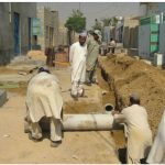 Orangi Pilot Project volunteers help build a lane sewer in Gulshan-e-Zia, Karachi, Pakistan.