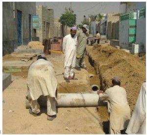 Orangi Pilot Project volunteers help build a lane sewer in Gulshan-e-Zia, Karachi, Pakistan.