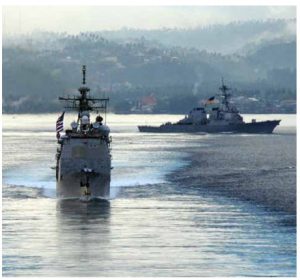 Guided-missile destroyers USS Cowpens (foreground) and USS Fitzgerald sail in formation in the Pacific. A close-call took place between the USS Cowpens and a small Chinese warship accompanying the Liaoning in December.