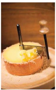 The girolle is a hand-operated device that scrapes the cheese off in fancy delicate  rosettes.