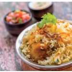 Biryani is a combination of spiced rice, usually cooked with meat or chicken and often vegetables as well.