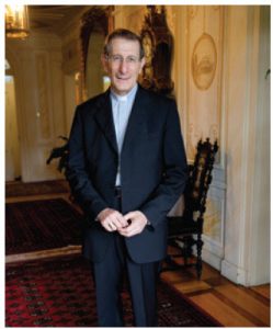 His Excellency, Most Reverend Luigi Bonazzi poses amid the frescoes at his residence.