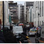 Police officers, emergency vehicles and journalists at the scene two hours after the shooting at French satirical magazine, Charlie Hebdo.