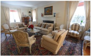The home features plenty of space for entertaining, including this main drawing room, which features an antique Kerman rug, a reminder of Mrs. Delcorde’s Iranian heritage. 