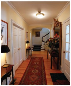 The home’s front hall has grand features, including a floor-to-ceiling antique gold mirror. 