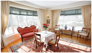 A dining room addition has created a bright and sunny room — cozy regardless of season — with views over the expansive gardens. 