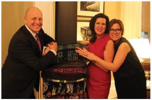 Artist Marie Watt, right, and Bruce and Vicki Heyman stand with Watt’s blanket sculpture, which has spent the year at the ambassador’s residence as part of Art in Embassies. (Photo: Embassy of the United States)