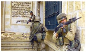 U.S. Marines prepare to enter one of Saddam Hussein’s palaces in Bagdad during Operation Iraqi Freedom in 2003. Ambassador Kaab says this invasion brought a fragile democracy to Iraq. (Photo: U.S. Army)