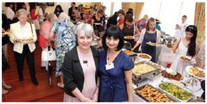 Professor Janine Krieber, wife of Foreign Minister Stéphane Dion, and Maria Yeganian, vice-president of HOMSA and wife of the Armenian ambassador, stand by the buffet lunch, which was donated by diplomatic spouses. (Photo: Sam Garcia)