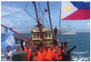 Filipino youth activists from the Kalayaan Atin Ito (Freedom is Ours) group, planted Philippines and United Nations flags on the Scarborough Shoal to mark the Filipino National Day. (Photo: Kalayaan Atin Ito Movement)
