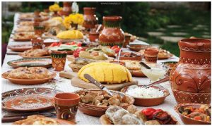 Traditional Moldovan dishes: Mamaliga (corn bread), placinte (vegetable stuffed pie), friptura (traditional pork stew), grilled vegetables and pickles. (Photo: Maxim Chumash)