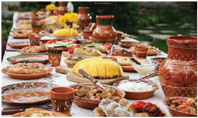Traditional Moldovan dishes: Mamaliga (corn bread), placinte (vegetable stuffed pie), friptura (traditional pork stew), grilled vegetables and pickles. (Photo: Maxim Chumash)