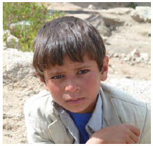 A boy in the Sa'ada governorate. Like their older counterparts, young boys always wear sports jackets over their traditional dress. 