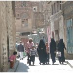 Locals in the old city of Sanaa. Almost all Yemeni women wear a niqab or hijab in public.