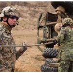 Canadian, American, and Latvian vehicle technicians practise their recovery drills in Latvia. Canada has troops on the ground there as part of an allied operation. (Photo: MCpl Jennifer Kusche, Canadian Forces Combat Camera)