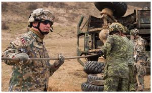 Canadian, American, and Latvian vehicle technicians practise their recovery drills in Latvia. Canada has troops on the ground there as part of an allied operation. (Photo: MCpl Jennifer Kusche, Canadian Forces Combat Camera)