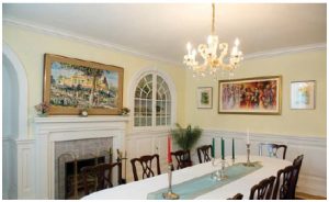 The main dining room, with a display cabinets and two large paintings depicting traditional scenes from Pakistan. (Photo: Ashley Fraser)