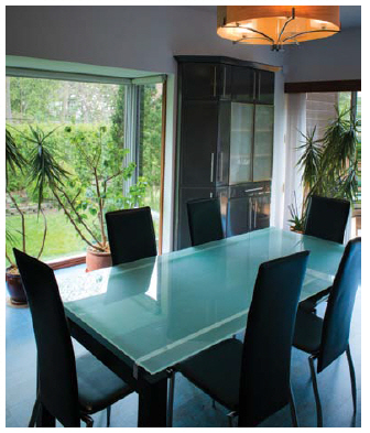 This breakfast table looks out on the garden and opens to the patio deck. (Photo:  Ashley Fraser)