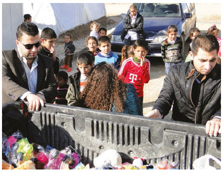 Yazidis in Iraq receive aid and toys for their children from Defend International. (Photo: Defend International)