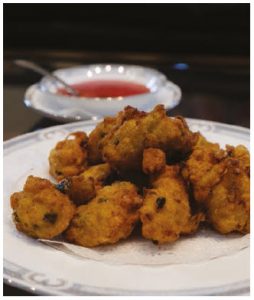 These shrimp fritters are served with a sweet and spicy chili sauce. (Photo: Dyanne Wilson)