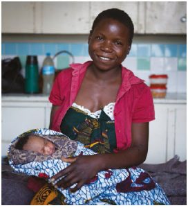 Zaituni and her baby, Mariam, in the post-natal ward at Kiomboi Hospital, Iramba, Tanzania. The mother almost died in childbirth from post-birth sepsis likely caused by washing in dirty pond water. (Photo: WaterAid, Anna Kari)