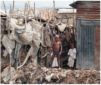 Haiti is one of the most densely populated and poorest countries in the Americas. These Haitian children are standing outside the shack that serves as their home. (Photo: UN)