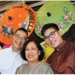 The Amazing Thailand Festival, held at the Horticulture Building of Lansdowne Park, featured cultural shows, handicrafts and food. From left: Thai Ambassador Maris Sangiampongsa, his wife, Kokan, and son, Chain, with colourful Thai umbrellas. (Photo: Ülle Baum)
