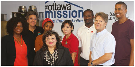 Staff from the South African High Commission help out at The Ottawa Mission. From left, South African High Commissioner Sibongiseni Dlamini-Mntambo, social secretary Trudi Hogue, third secretary Nondlela Maponya, receptionist Lea Allen, accountant Julia Shin, administrative clerk Lunga Majombozi, The Ottawa Mission’s executive director Peter Tilley and first secretary Fernando Slawers.