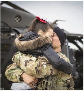 U.S. Army Chief Warrant Officer 3 Austin Randolph hugs his daughter, Elliana, before taking off for a deployment in support of Operation Freedom's Sentinel in Afghanistan. (Photo: U.S. AIR NATIONAL GUARD PHOTO BY MASTER SGT. MATT HECHT)
