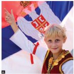 The 14th Annual Serbian Festival, featuring folklore dancing and authentic food, took place on the grounds of St. Stefan Serbian Orthodox Church. Standing next to the Serbian flag is Teodora, a member of Kolo, a Serbian folk dance group that performed at the event. (Photo: Ülle Baum)