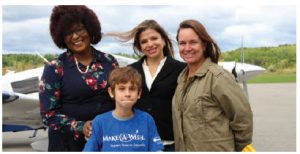 Rio Sarrazin, front, got his wish to fly over the city of Ottawa at the Ottawa Diplomatic Association's Fly Day. He's shown with, from left, South African High Commissioner Sibongiseni Dlamini-Mntambo, Honduran Ambassador Sofia Cerrato and his mom, Melanie Smith. (Photo: Ülle Baum)