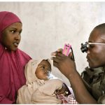 Africa’s bill of health is steadily improving, thanks to medical science, special attention to chronic disease and several American philanthropic enterprises. Here, a Ugandan medic examines a young girl's eyes during an outpatient day for civilians in Mogadishu. (Photo: UN photo)