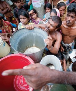 WaterAid says that if a single bucket were to hold all the water in the world, only a teacup if it would be potable and of that, only a teaspoon would be accessible. These residents of Old Dhaka, Bangladesh, are being given water by the military.  (Photo: Kibae Park/Sipa Press - UN photo)