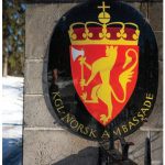 The Norwegian coat of arms is on the roadside gate at the residence. (Photo: Ashley Fraser)