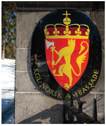 The Norwegian coat of arms is on the roadside gate at the residence. (Photo: Ashley Fraser)